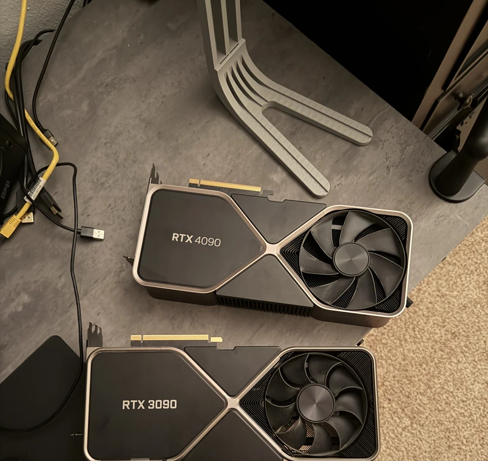 An NVIDIA RTX 4090 and RTX 3090 laid out on Austin’s workbench
