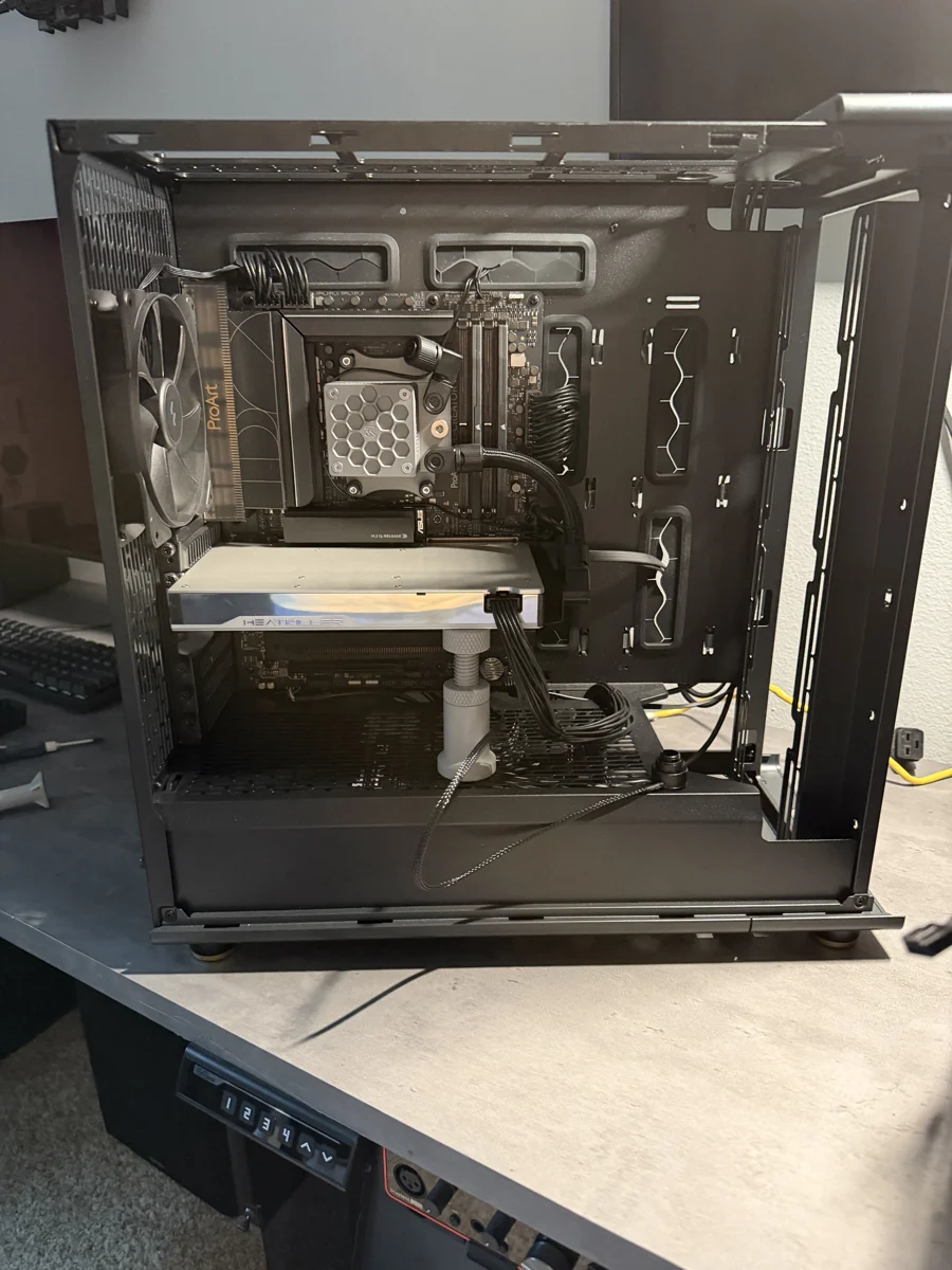 An open workstation during assembly, with liquid cooling and multiple graphics cards installed