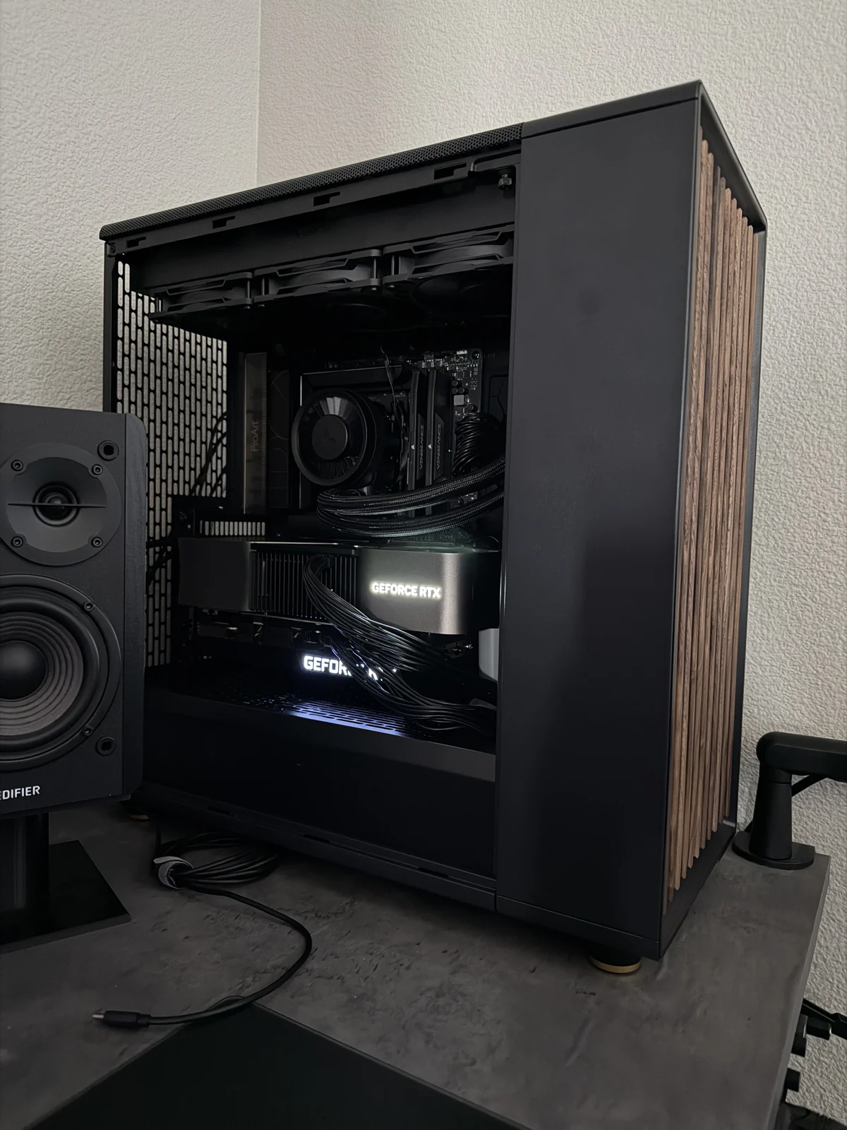 An open workstation built by Austin Winn, showing the GPU and cooling hardware inside a wood-front case